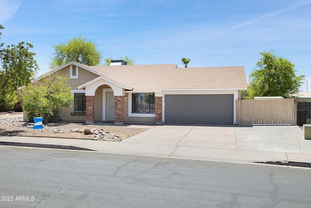 7337 E Ivyglen St, Mesa, AZ 85207 - view of front of property featuring a garage, driveway, a shingled roof, brick siding, and stucco siding