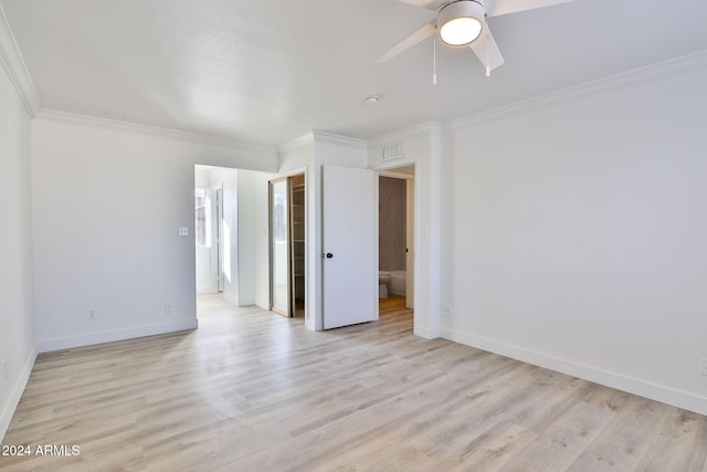 unfurnished room featuring ceiling fan, light wood-type flooring, and crown molding