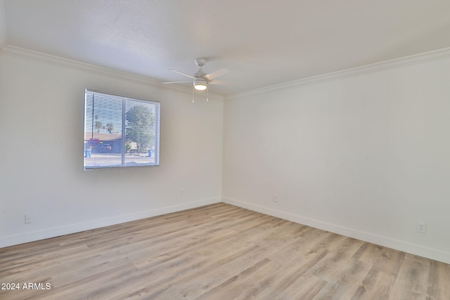 spare room featuring light wood-type flooring, ceiling fan, and ornamental molding