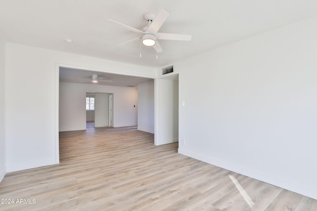 spare room with ceiling fan and light wood-type flooring