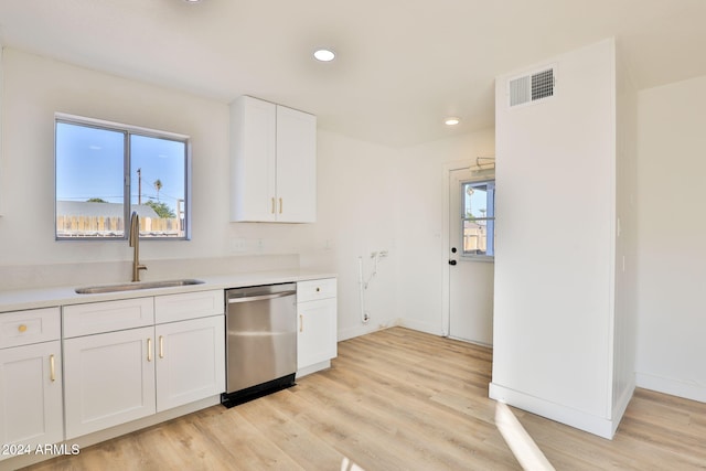 kitchen with dishwasher, light wood-type flooring, white cabinetry, and sink