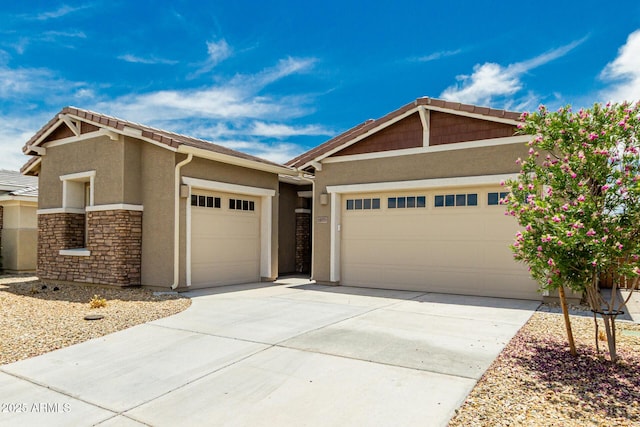 19151 W Coolidge St, Litchfield Park, AZ 85340 - craftsman-style house featuring an attached garage, stucco siding, concrete driveway, and stone siding