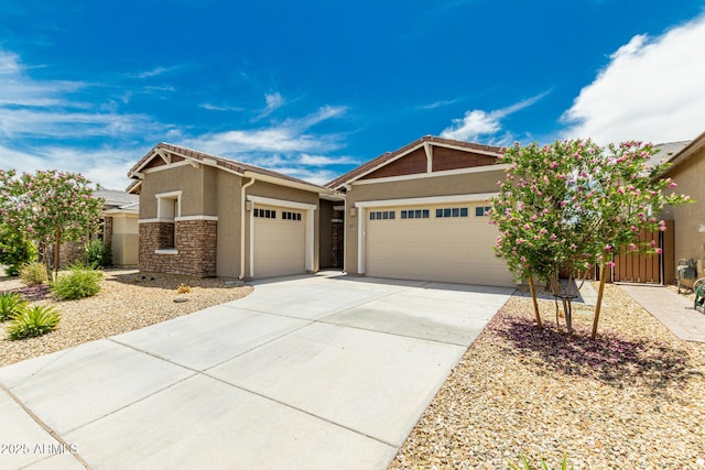 19151 W Coolidge St, Litchfield Park, AZ 85340 - craftsman-style house with a garage, stucco siding, driveway, and stone siding
