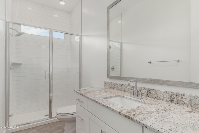 19151 W Coolidge St, Litchfield Park, AZ 85340 - bathroom with vanity, toilet, a stall shower, and wood finished floors