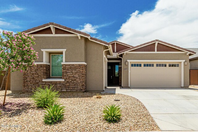 19151 W Coolidge St, Litchfield Park, AZ 85340 - craftsman inspired home featuring stucco siding, a garage, driveway, and stone siding