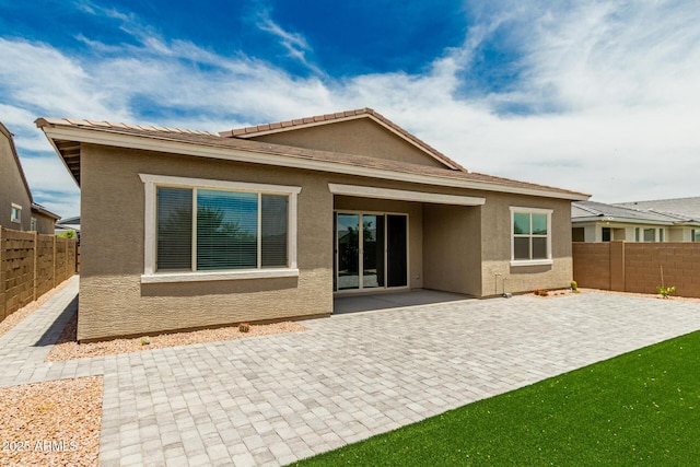 19151 W Coolidge St, Litchfield Park, AZ 85340 - rear view of house featuring a fenced backyard, a patio, and stucco siding