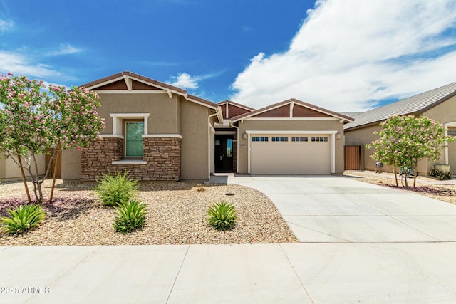 19151 W Coolidge St, Litchfield Park, AZ 85340 - craftsman-style house featuring an attached garage, stucco siding, concrete driveway, and stone siding