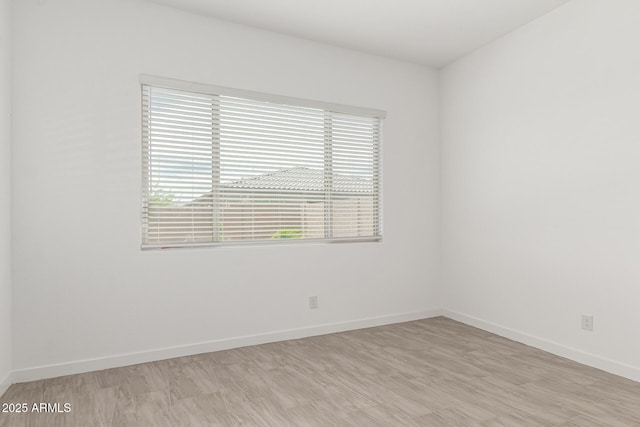 19151 W Coolidge St, Litchfield Park, AZ 85340 - empty room with plenty of natural light, baseboards, and light wood-style flooring
