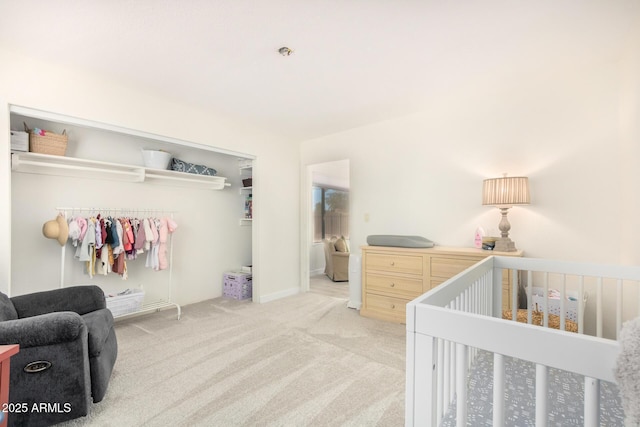 carpeted bedroom featuring a crib