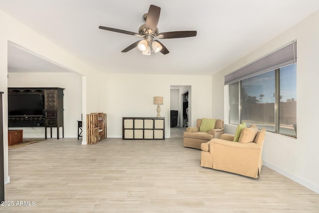 living room featuring ceiling fan and light hardwood / wood-style floors