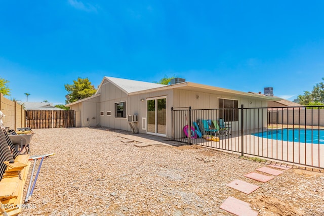 rear view of property featuring central AC, a patio area, and a fenced in pool