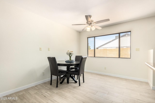 dining area with ceiling fan and light hardwood / wood-style flooring