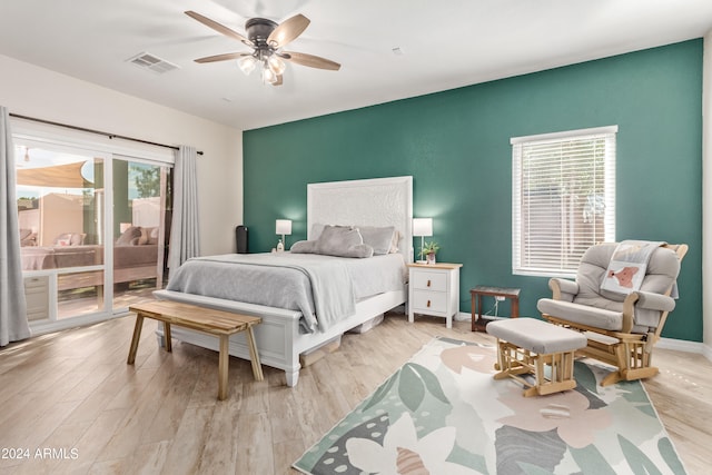 bedroom featuring multiple windows, light wood-type flooring, and ceiling fan