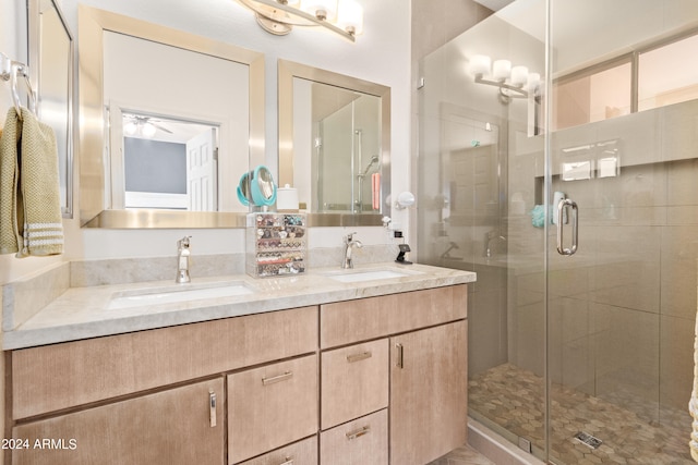 bathroom featuring vanity, ceiling fan, and an enclosed shower