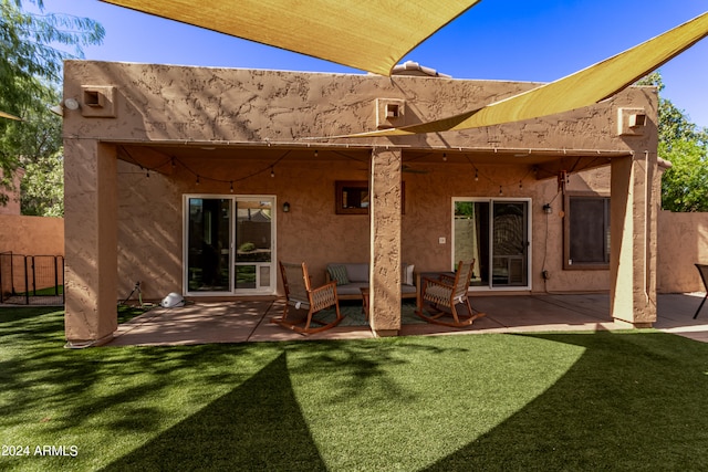 back of property featuring a yard and a patio area