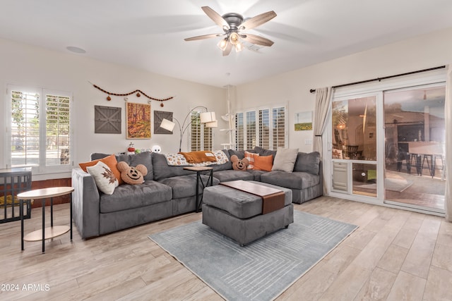 living room featuring light hardwood / wood-style flooring and ceiling fan