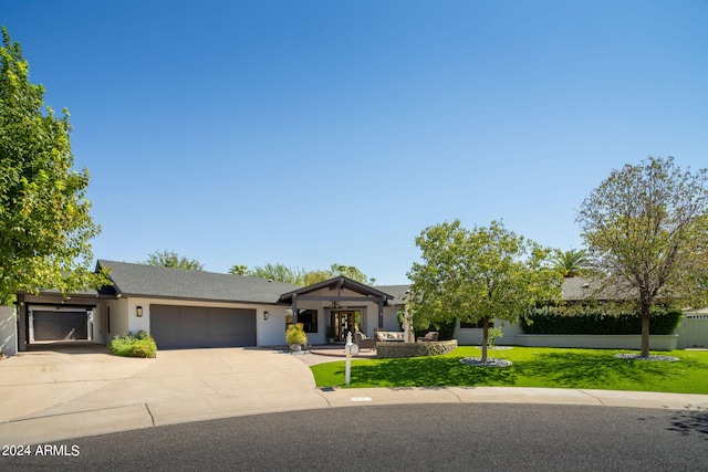 view of front of home featuring a garage and a front lawn