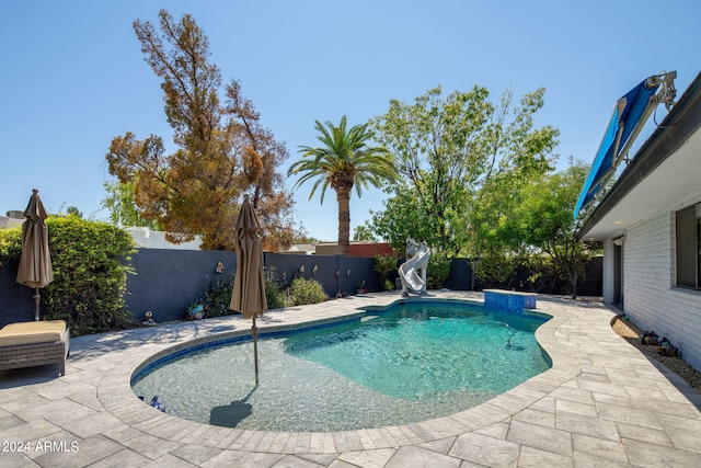 view of pool with a patio and a water slide