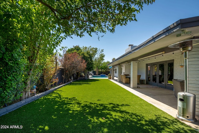 view of yard featuring french doors and a patio area