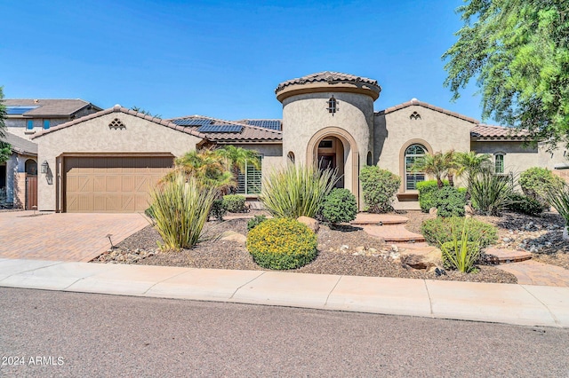 mediterranean / spanish-style house featuring a garage