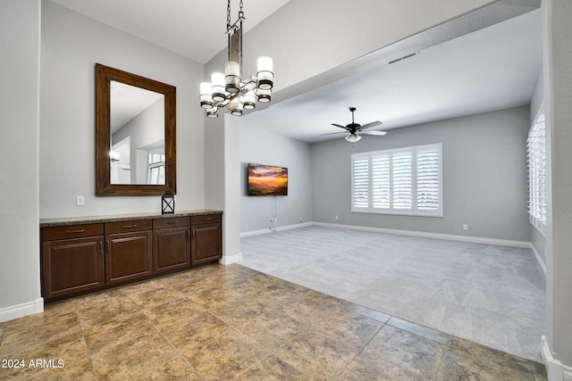 interior space featuring ceiling fan with notable chandelier