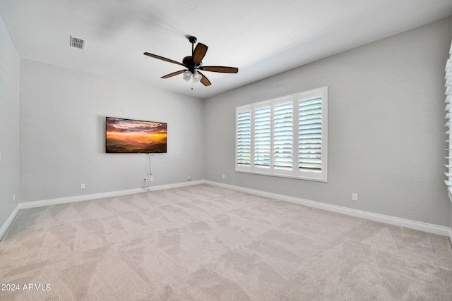 carpeted spare room featuring ceiling fan