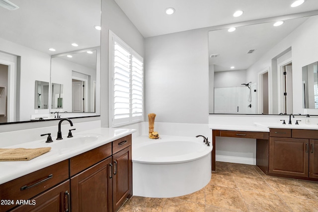 bathroom with vanity and independent shower and bath