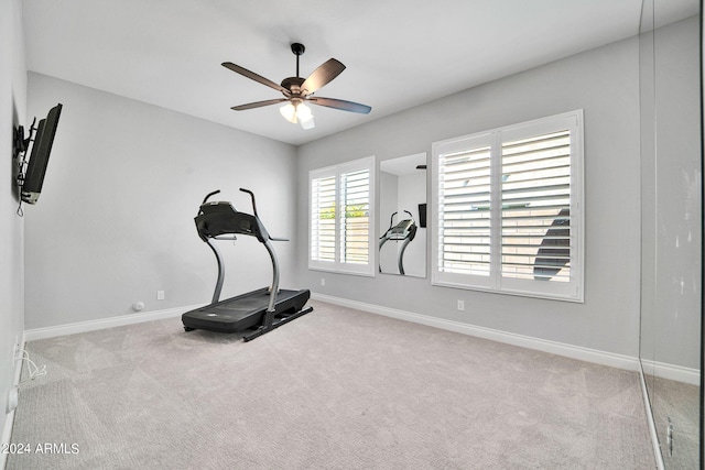 exercise room featuring ceiling fan and light carpet