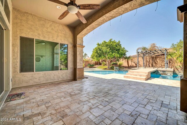 view of pool featuring a patio, ceiling fan, and an in ground hot tub