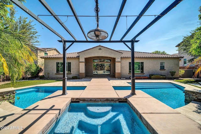 view of swimming pool featuring a patio and a jacuzzi