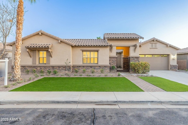 mediterranean / spanish-style home with a garage and a front yard