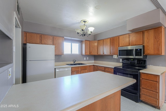 kitchen with white appliances, hanging light fixtures, an inviting chandelier, and sink