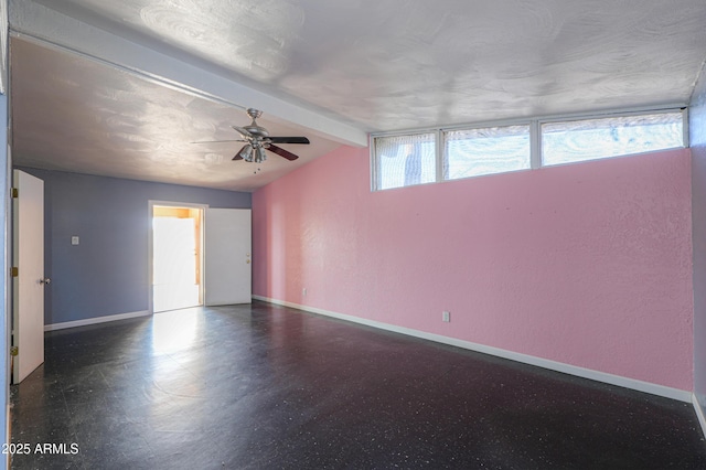 unfurnished room featuring ceiling fan and vaulted ceiling with beams