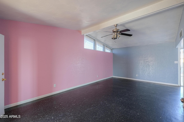 empty room featuring ceiling fan and vaulted ceiling with beams