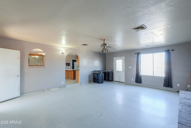 unfurnished living room with ceiling fan