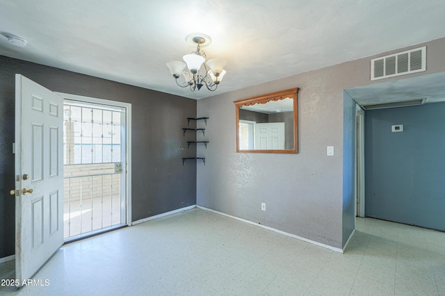 spare room with an inviting chandelier