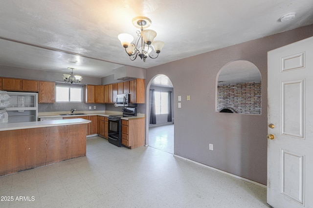 kitchen featuring a notable chandelier, a healthy amount of sunlight, decorative light fixtures, and black electric range oven