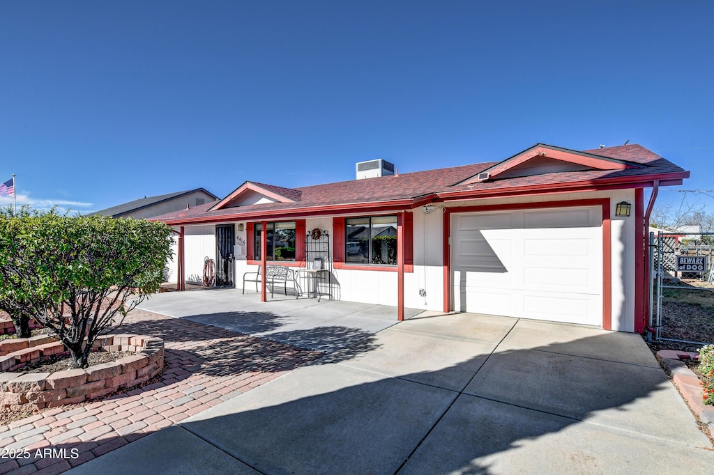 single story home featuring a porch and a garage