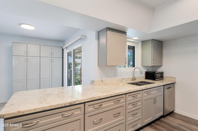 kitchen featuring gray cabinetry, stainless steel dishwasher, dark wood-type flooring, a sink, and black microwave