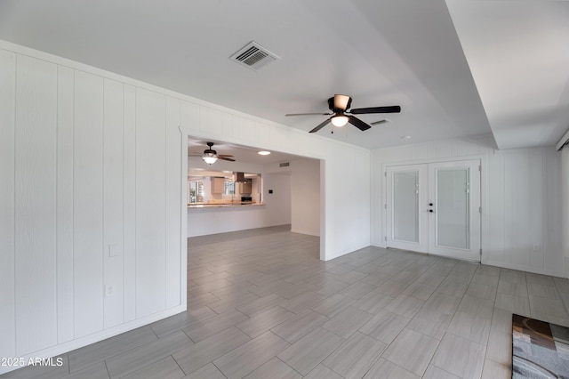 unfurnished living room featuring ceiling fan, french doors, and visible vents