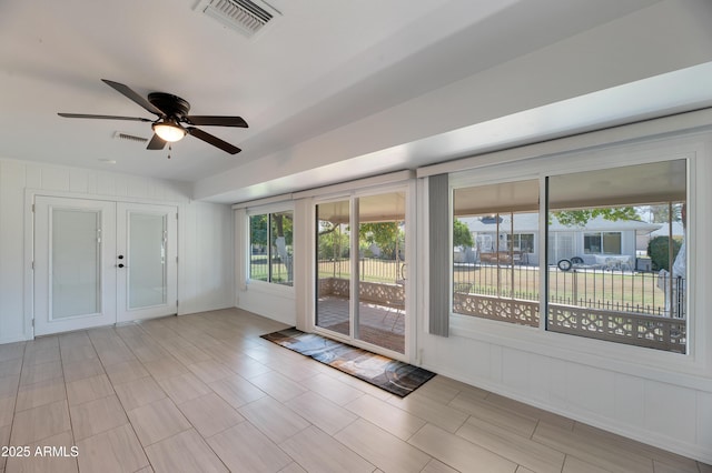 doorway featuring ceiling fan and visible vents