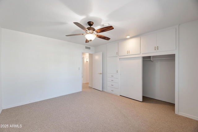 unfurnished bedroom with light carpet, baseboards, visible vents, ceiling fan, and a closet