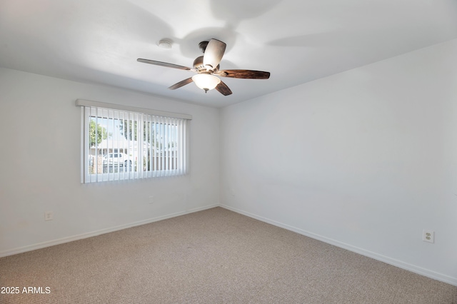 empty room featuring a ceiling fan, light carpet, and baseboards