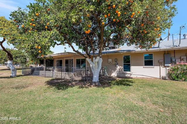 view of front of property with a front lawn, a patio area, and fence