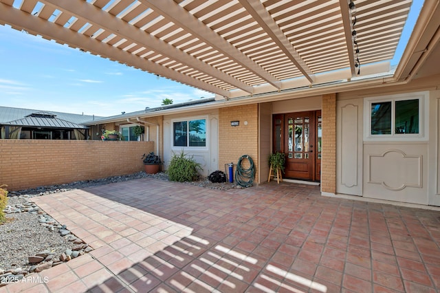 view of patio featuring fence and a pergola