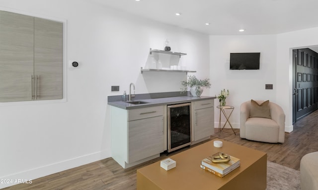 interior space featuring wine cooler, light wood-type flooring, and sink