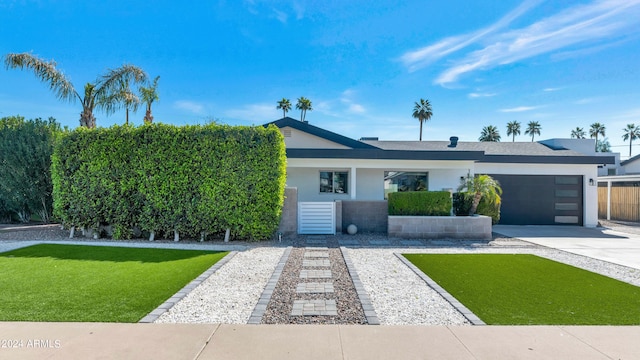 view of front of home with a garage and a front yard