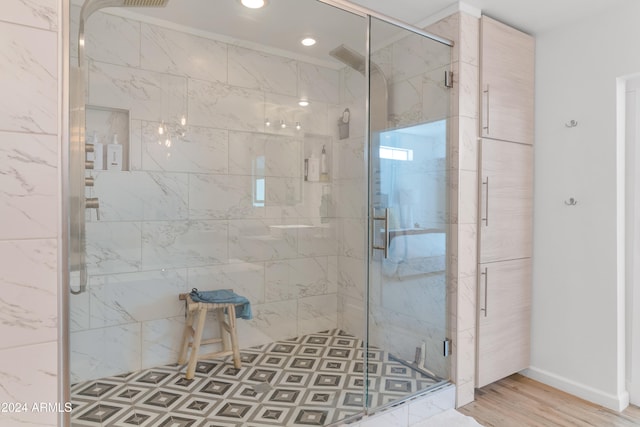 bathroom featuring an enclosed shower and wood-type flooring