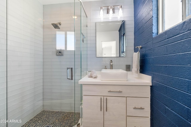 bathroom featuring vanity and a shower with shower door