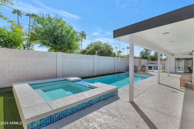 view of pool featuring an in ground hot tub and a patio